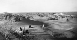 Landscape and figures along the Tarim River on Hedin's Second Expedition, 1900.